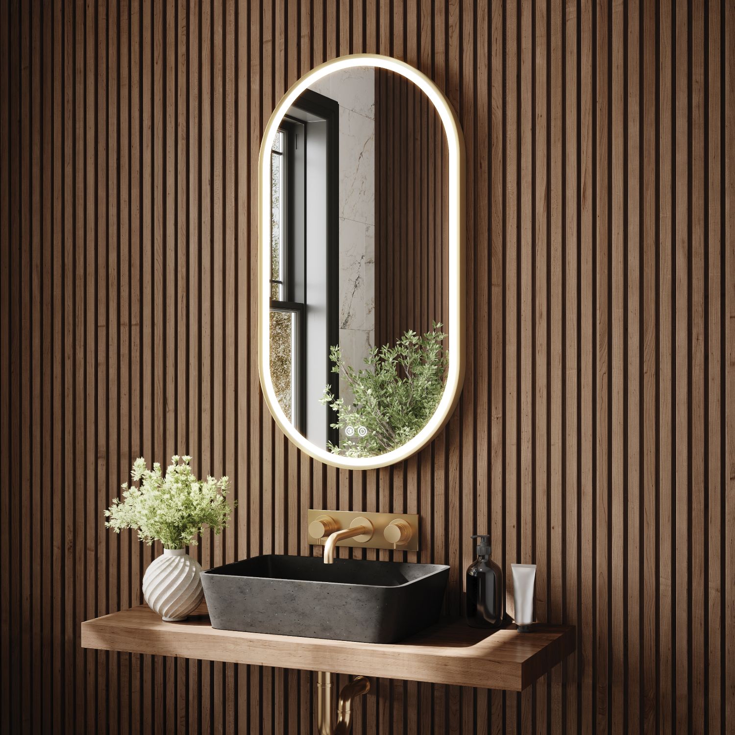 Fleurco oval lighted mirror with brass frame above a vessel sink
